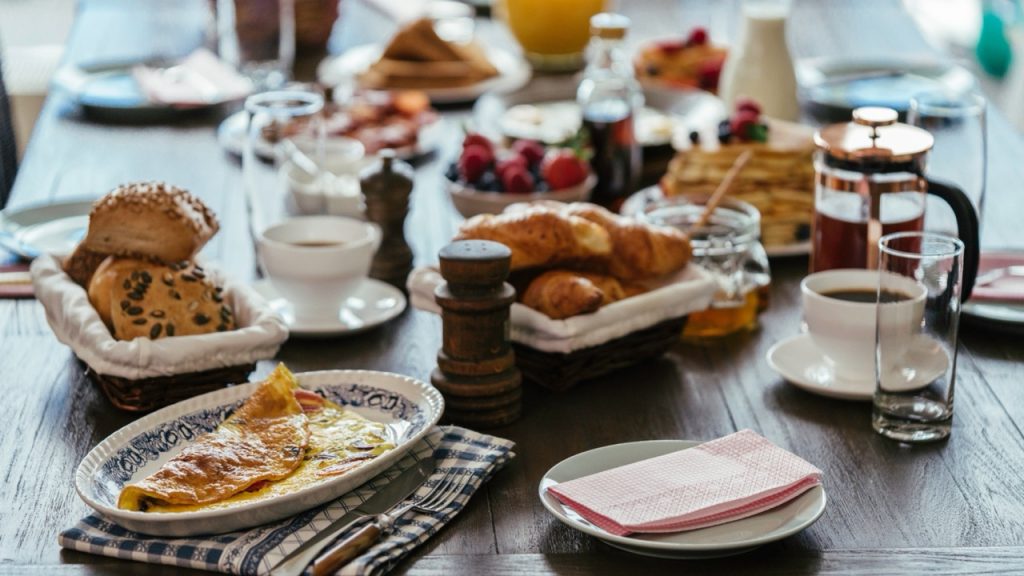 Lots of breakfast dishes on a table